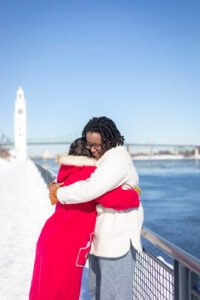 A joyful close-up of Josee and Olivia celebrating their engagement in the snowy Old Port.