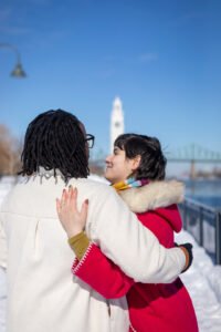 A joyful close-up of Josee and Olivia celebrating their engagement in the snowy Old Port.