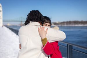 Josee and Olivia sharing an emotional hug immediately after the surprise proposal in Old Port Montreal.