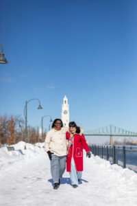 Josee and Olivia walking toward the Montreal Clock Tower in the snow before the surprise proposal.
