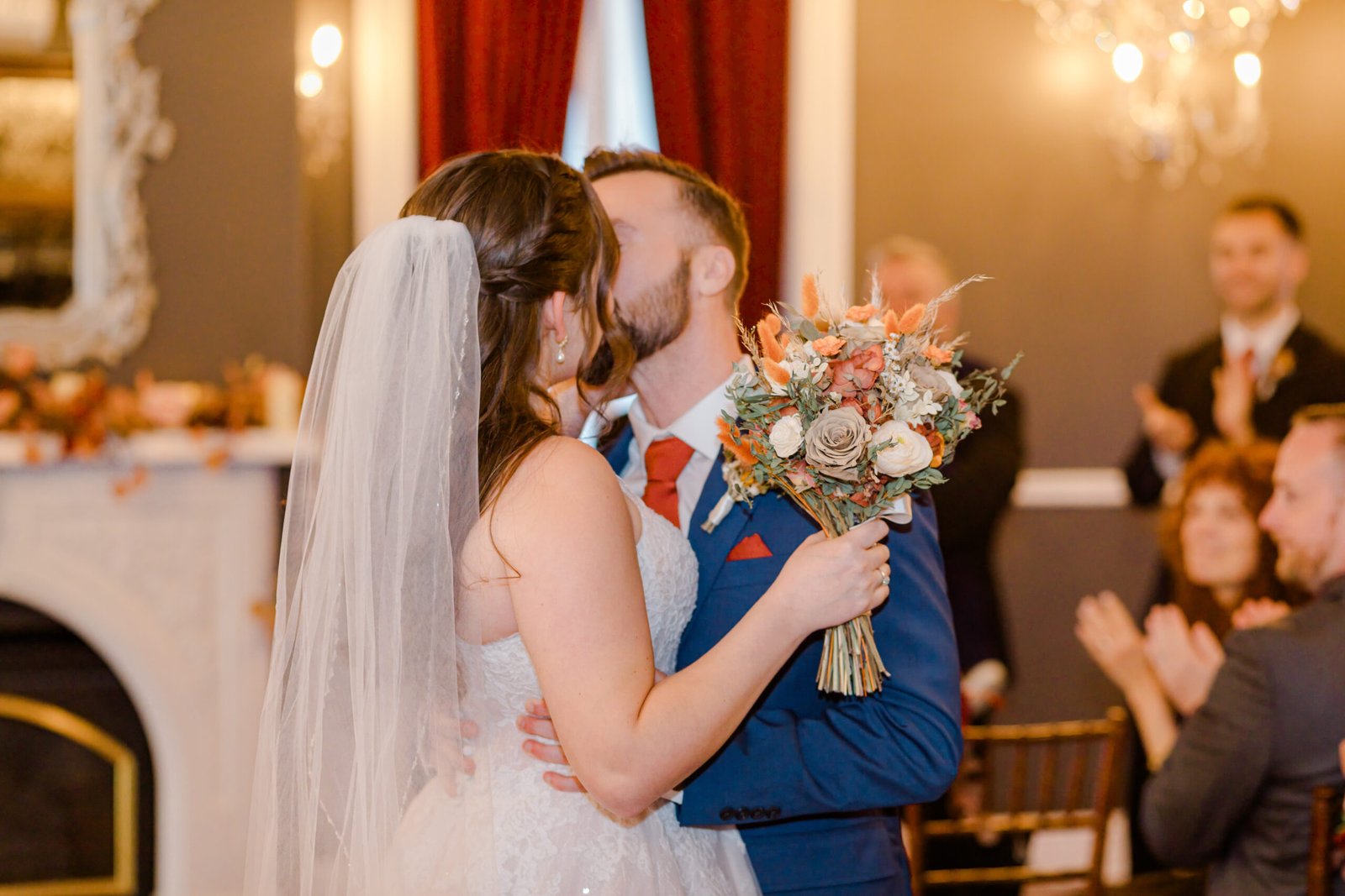 Toronto wedding couple kissing in front of a fireplace