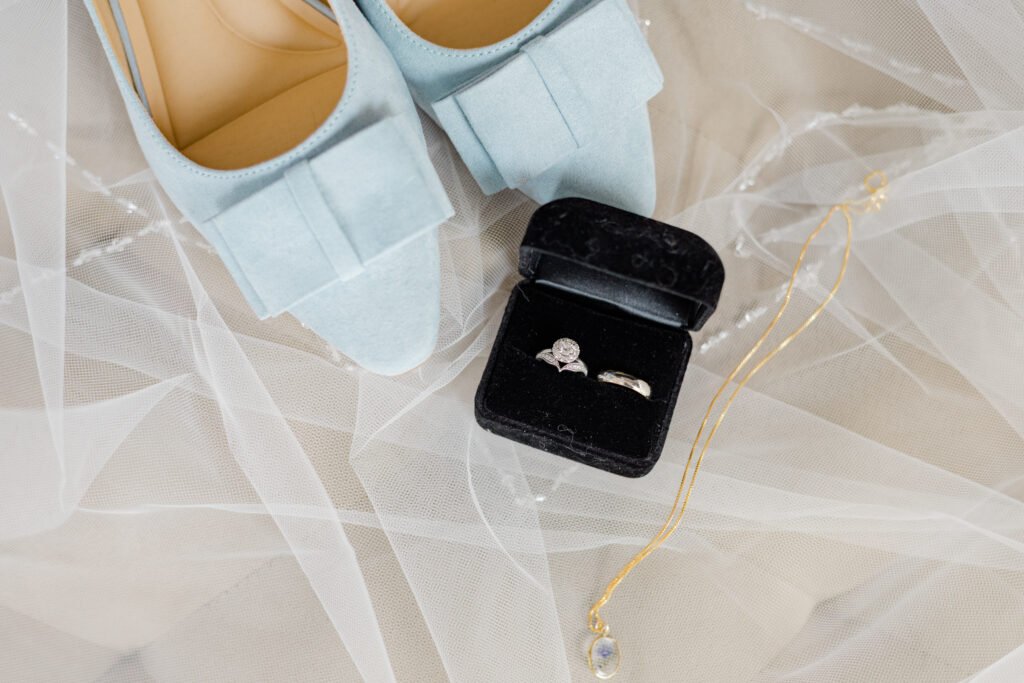 Montreal wedding detail flat lay with shoes, rings, and veil